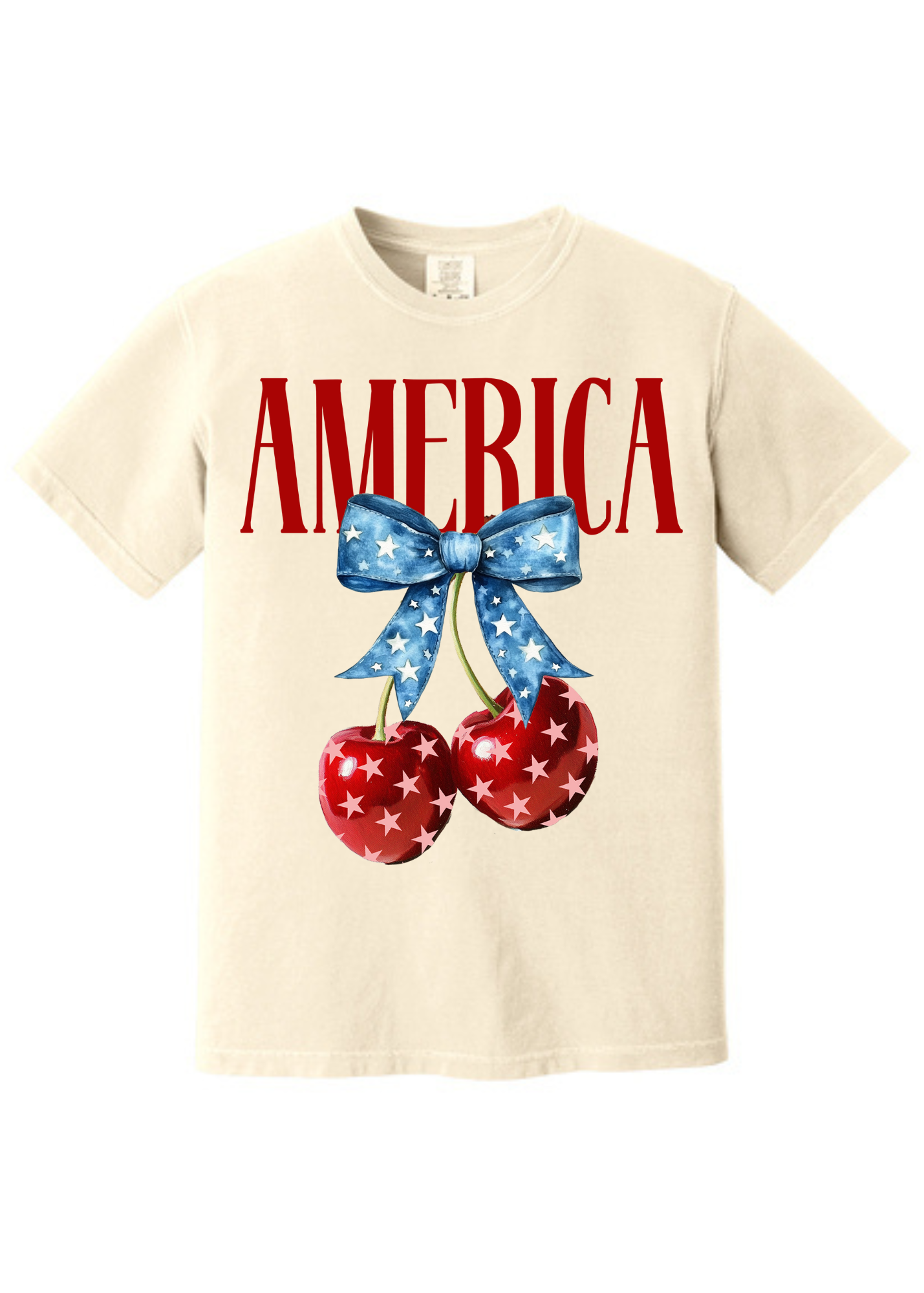 Cream-colored unisex t-shirt featuring bold red “AMERICA” text across the chest. Below, two glossy red cherries with white stars hang from a vibrant blue bow decorated with a star pattern, creating a playful and patriotic summer design. Classic crew neck and short sleeves make it perfect for 4th of July festivities or showing off your American pride with a sweet twist.
