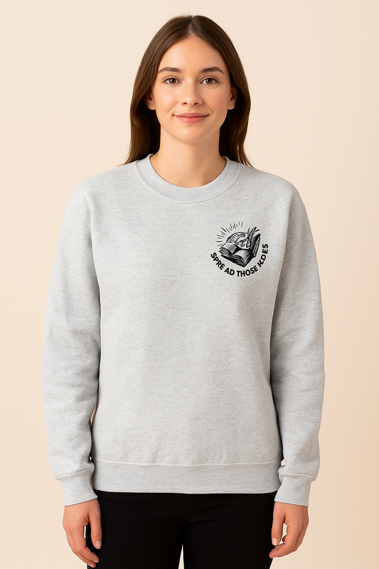 Light gray crewneck sweatshirt featuring bold black bookish graphics. The front chest has a small open-book design with a hand and the phrase “Spread Those Pages.” The back showcases a full skeleton girl reading, surrounded by stacked books, coffee, and sparkles. Large text reads: “I Look Better Bent Over a Book – Proud Smut Reader.” A cozy, cheeky must-have for spicy book lovers with a sense of humor.