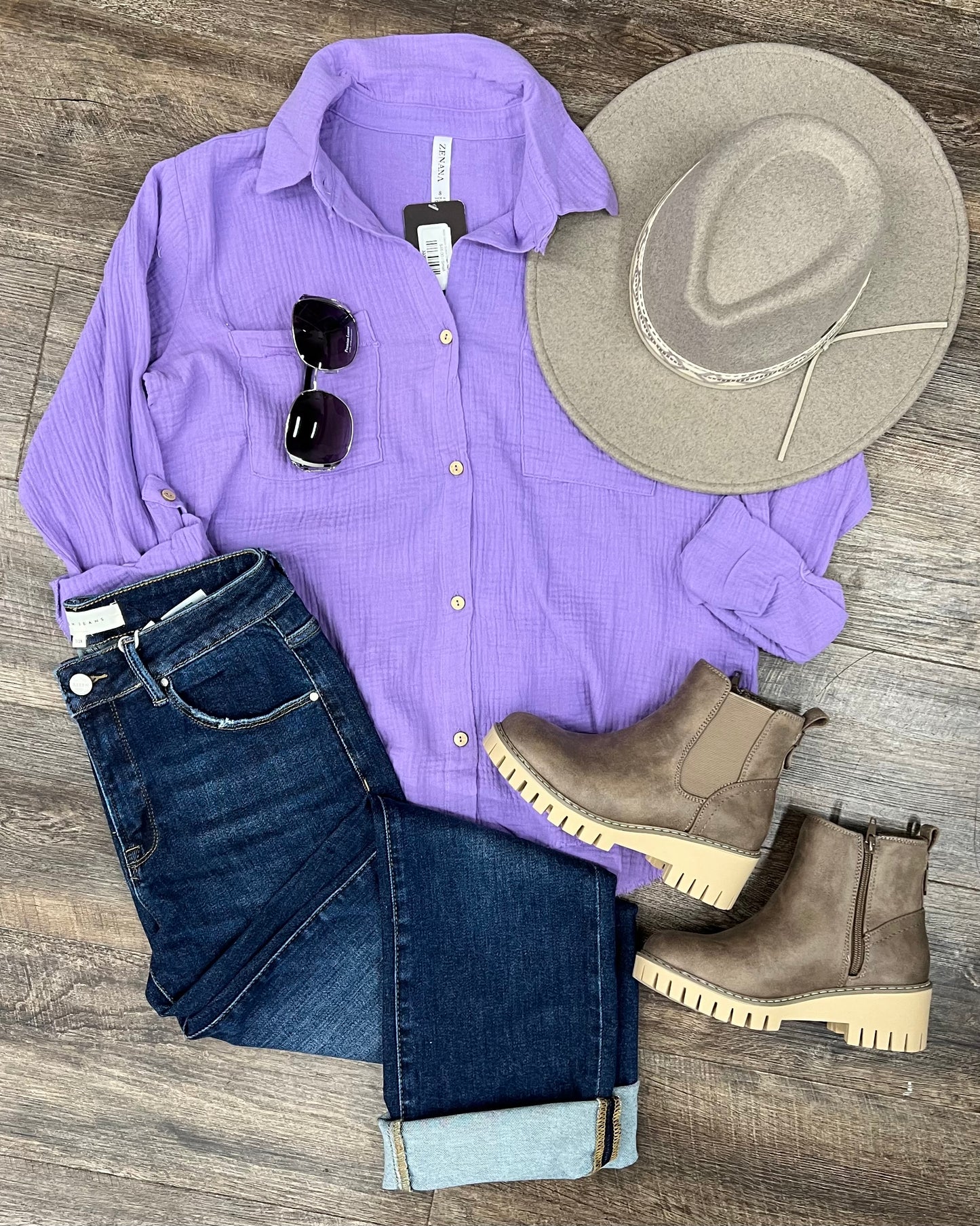 Textured lavender button-down shirt with a relaxed, oversized fit and lightweight gauze fabric. Features raw-edge hems, double chest pockets, wood-look buttons, and roll-tab sleeves. A breezy, versatile layer for spring and summer that pairs effortlessly with denim, tanks, or swimwear.