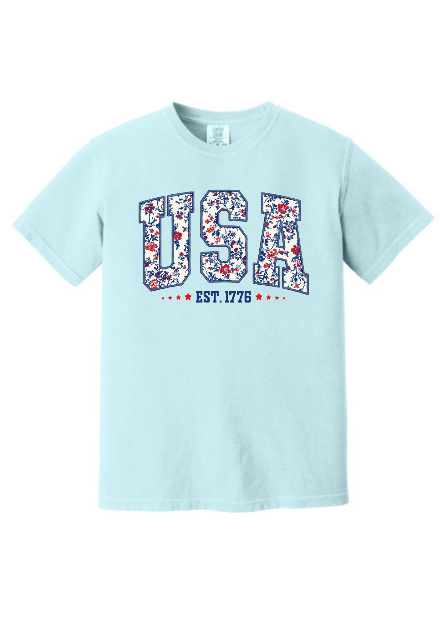 Light blue unisex t-shirt featuring bold "USA" block letters filled with a red, white, and blue floral pattern for a faux-embroidered look. Below, "EST. 1776" is printed in navy with red stars, celebrating American heritage. Classic crew neck and short sleeves offer a comfortable fit, perfect for patriotic holidays like the Fourth of July or Memorial Day.