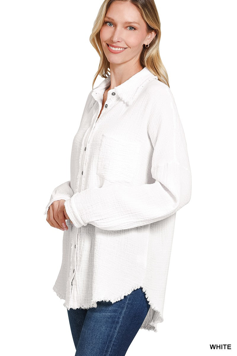 Women's oversized button-down gauze shirt in crisp white, featuring a textured crinkle fabric with a soft, breathable feel. Designed with a front chest pocket, raw-edge hemline, and functional silver snap buttons. Long sleeves with drop shoulders and a relaxed fit for effortless layering over tanks or tees. Lightweight yet cozy—perfect for tossing on during breezy summer nights or early fall mornings.