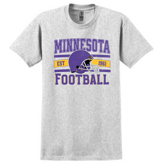 A gray t-shirt with the text 'Minnesota Football' and a purple graphic of a football helmet, indicating a retro style and the state of Minnesota.