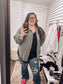 Women's oversized button-down shirt in light olive, crafted from a textured gauze fabric for a breathable and lived-in feel. Features raw-edge detailing on the collar and hem, front chest pocket, and functional button closures down the front. Drop shoulders and a relaxed fit make it ideal for layering over tanks or tees. A soft, casual essential for effortless cool-weather layering or breezy summer nights.