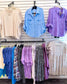 Lightweight and breezy button-down shirt in a soft, crinkled gauze fabric, featured in a fresh Spring Blue. Designed with dual chest pockets, raw-edge hem, and rolled long sleeves with button tabs. Slightly oversized fit for easy layering over tanks, tees, or swimsuits—perfect for casual days, lake life, or cool summer nights.