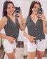 Woman wearing a sleeveless black and white horizontal striped tank top with a deep V-neckline and functional wooden buttons down the front. The top features a trendy front tie detail at the hem, creating a casual, flattering silhouette. Made from a soft, lightweight fabric, it's styled with medium-wash denim jeans—perfect for laid-back summer days, weekend outings, or everyday wear.