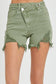 High-rise olive denim shorts with edgy angled hems and heavy distressing on the front thighs. Designed with a raw, frayed finish and exposed pocket lining for a laid-back, worn-in vibe. Features a zip fly with double-button closure and classic five-pocket styling. A bold twist on your go-to cutoffs—perfect for pairing with tanks, graphic tees, or festival fits.