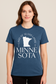 Heathered blue unisex t-shirt featuring a bold white graphic of the state of Minnesota, with the phrase “Land of 10,000 Lakes” encircling the silhouette. Below the graphic, elegant serif text reads “MINNESOTA” split across two lines. Includes subtle “ESTD 1858” details, nodding to the state's founding. Soft cotton-blend fabric with a classic fit—perfect for showing off Midwest pride in comfort and style.