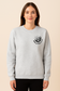 Light gray crewneck sweatshirt featuring bold black bookish graphics. The front chest has a small open-book design with a hand and the phrase “Spread Those Pages.” The back showcases a full skeleton girl reading, surrounded by stacked books, coffee, and sparkles. Large text reads: “I Look Better Bent Over a Book – Proud Smut Reader.” A cozy, cheeky must-have for spicy book lovers with a sense of humor.