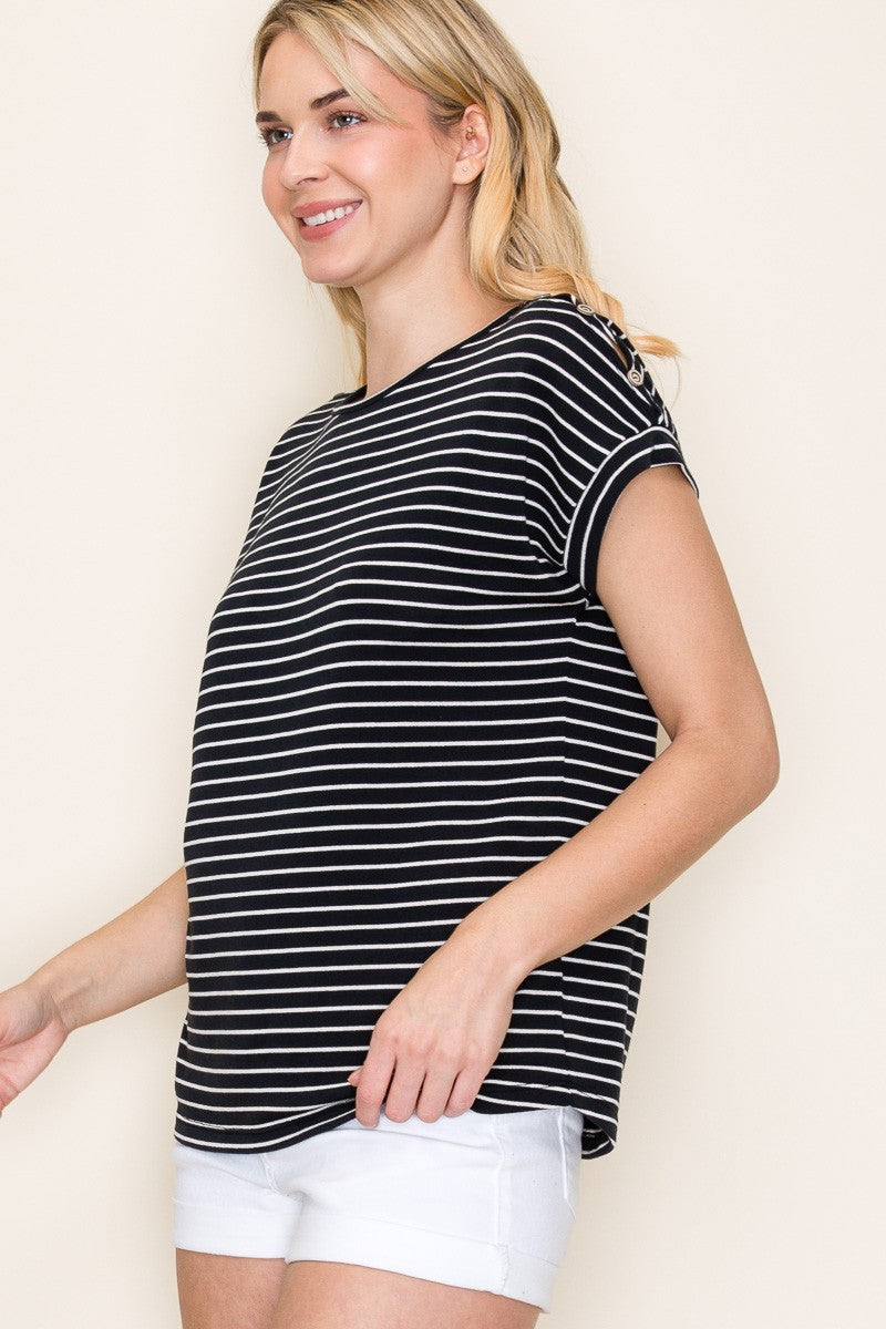 Woman wearing a black short-sleeve top with thin white horizontal stripes, a classic crew neckline, and rolled cuff sleeves with button accents. The top features a relaxed, drapey fit that pairs effortlessly with white cuffed shorts for a crisp, casual look. Perfect for everyday wear, this lightweight striped tee brings timeless style and comfort to your summer wardrobe.