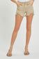 High-rise tan denim shorts with a perfectly lived-in look, featuring heavy distressing along the raw hem and side slits for extra edge. Classic five-pocket design with frayed detailing at the waistband and front pockets. These neutral cutoffs are easy to pair with any summer tank or graphic tee, making them a go-to for lake days, festivals, or backyard hangs.