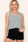Woman wearing a casual sleeveless tank top with horizontal forest green and white stripes. The top features a scoop neckline and a relaxed, slightly flared silhouette that offers a breezy, comfortable fit. Styled with distressed dark-wash denim shorts, this easygoing look is perfect for everyday wear, beach days, or layering under summer cardigans and jackets.