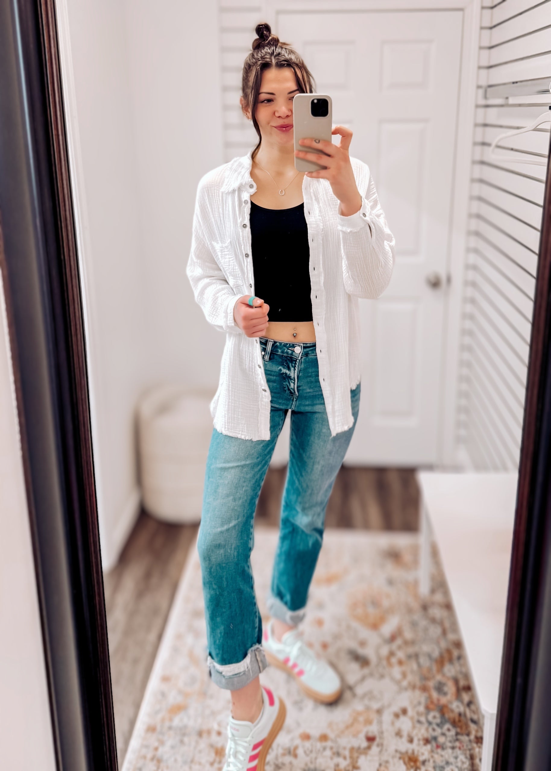 Women's oversized button-down gauze shirt in crisp white, featuring a textured crinkle fabric with a soft, breathable feel. Designed with a front chest pocket, raw-edge hemline, and functional silver snap buttons. Long sleeves with drop shoulders and a relaxed fit for effortless layering over tanks or tees. Lightweight yet cozy—perfect for tossing on during breezy summer nights or early fall mornings.