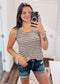 Woman wearing a casual sleeveless tank top with horizontal taupe and white stripes. The top features a scoop neckline and a relaxed, slightly flared silhouette that offers a breezy, comfortable fit. Styled with distressed dark-wash denim shorts, this easygoing look is perfect for everyday wear, beach days, or layering under summer cardigans and jackets.