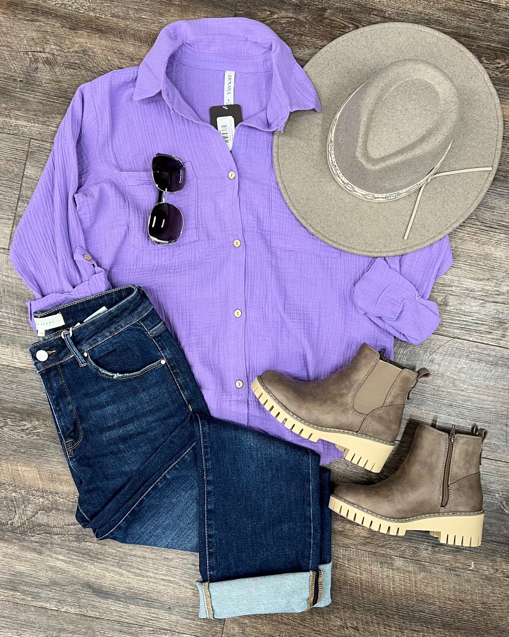 Textured lavender button-down shirt with a relaxed, oversized fit and lightweight gauze fabric. Features raw-edge hems, double chest pockets, wood-look buttons, and roll-tab sleeves. A breezy, versatile layer for spring and summer that pairs effortlessly with denim, tanks, or swimwear.