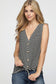 Woman wearing a sleeveless black and white horizontal striped tank top with a deep V-neckline and functional wooden buttons down the front. The top features a trendy front tie detail at the hem, creating a casual, flattering silhouette. Made from a soft, lightweight fabric, it's styled with medium-wash denim jeans—perfect for laid-back summer days, weekend outings, or everyday wear.