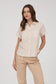 Short-sleeve button-up shirt in a neutral cream and tan stripe pattern, featuring a collared neckline and a chest pocket with horizontal stripe contrast. Lightweight, breathable fabric with a relaxed fit for everyday wear. A versatile top that pairs effortlessly with denim, trousers, or shorts for a casual yet polished look.