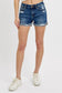 Medium-wash denim shorts featuring a mid-rise fit, cuffed raw hem, and distressed details throughout the front and pockets. These shorts blend laid-back edge with everyday comfort thanks to the soft stretch denim and versatile length. The perfect pair for casual summer days, music festivals, or throwing on over a swimsuit.