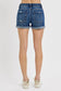 Medium-wash denim shorts featuring a mid-rise fit, cuffed raw hem, and distressed details throughout the front and pockets. These shorts blend laid-back edge with everyday comfort thanks to the soft stretch denim and versatile length. The perfect pair for casual summer days, music festivals, or throwing on over a swimsuit.