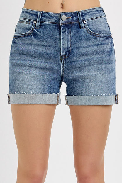 Medium-wash denim shorts featuring a high-rise fit with cuffed raw hems and subtle fading throughout. Designed with classic five-pocket styling and slight stretch for all-day comfort. These shorts hit that sweet spot between casual and polished—perfect for pairing with tanks, tees, or lightweight layers for a warm-weather go-to look.