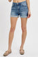 Medium-wash denim shorts featuring a high-rise fit with cuffed raw hems and subtle fading throughout. Designed with classic five-pocket styling and slight stretch for all-day comfort. These shorts hit that sweet spot between casual and polished—perfect for pairing with tanks, tees, or lightweight layers for a warm-weather go-to look.