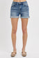 Medium-wash denim shorts featuring a high-rise fit with cuffed raw hems and subtle fading throughout. Designed with classic five-pocket styling and slight stretch for all-day comfort. These shorts hit that sweet spot between casual and polished—perfect for pairing with tanks, tees, or lightweight layers for a warm-weather go-to look.