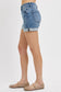 Medium-wash denim shorts featuring a high-rise fit with cuffed raw hems and subtle fading throughout. Designed with classic five-pocket styling and slight stretch for all-day comfort. These shorts hit that sweet spot between casual and polished—perfect for pairing with tanks, tees, or lightweight layers for a warm-weather go-to look.