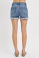 Medium-wash denim shorts featuring a high-rise fit with cuffed raw hems and subtle fading throughout. Designed with classic five-pocket styling and slight stretch for all-day comfort. These shorts hit that sweet spot between casual and polished—perfect for pairing with tanks, tees, or lightweight layers for a warm-weather go-to look.