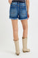 High-rise medium-wash denim shorts featuring a raw frayed hem with peekaboo white lining and light distressing along the edges. Designed with a classic five-pocket style and a flattering fit through the hips and thighs. These shorts are a laid-back summer staple—perfect for pairing with tanks, crop tops, or graphic tees for an effortlessly cool vibe