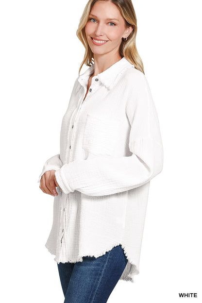 Women's oversized button-down gauze shirt in crisp white, featuring a textured crinkle fabric with a soft, breathable feel. Designed with a front chest pocket, raw-edge hemline, and functional silver snap buttons. Long sleeves with drop shoulders and a relaxed fit for effortless layering over tanks or tees. Lightweight yet cozy—perfect for tossing on during breezy summer nights or early fall mornings.