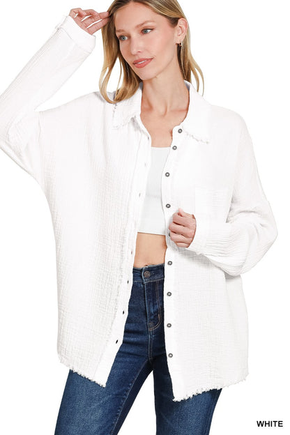 Women's oversized button-down gauze shirt in crisp white, featuring a textured crinkle fabric with a soft, breathable feel. Designed with a front chest pocket, raw-edge hemline, and functional silver snap buttons. Long sleeves with drop shoulders and a relaxed fit for effortless layering over tanks or tees. Lightweight yet cozy—perfect for tossing on during breezy summer nights or early fall mornings.