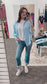 Lightweight and breezy button-down shirt in a soft, crinkled gauze fabric, featured in a fresh Spring Blue. Designed with dual chest pockets, raw-edge hem, and rolled long sleeves with button tabs. Slightly oversized fit for easy layering over tanks, tees, or swimsuits—perfect for casual days, lake life, or cool summer nights.